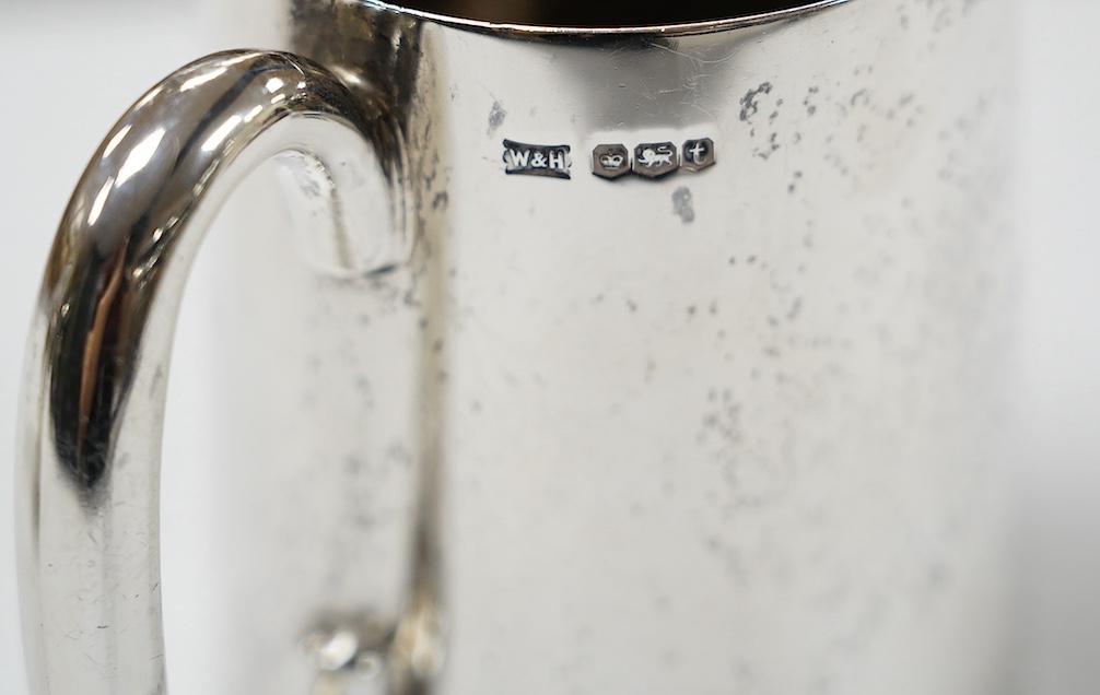 A George V silver mug, by Walker & Hall, Sheffield, 1936, 88mm, together with an earlier silver christening mug, 10.1oz. Condition - fair